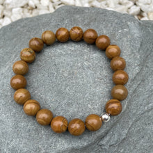Load image into Gallery viewer, Brown crystal bracelet on stone
