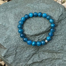 Load image into Gallery viewer, Blue crystal bracelet on stone
