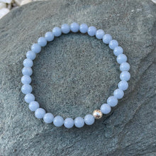 Load image into Gallery viewer, Blue crystal bracelet on stone

