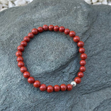 Load image into Gallery viewer, Red jasper beaded bracelet on stone
