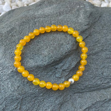 Load image into Gallery viewer, Yellow agate bracelet on stone
