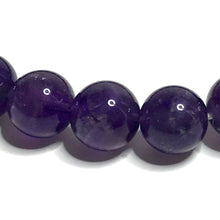 Load image into Gallery viewer, Close up of a handmade 8mm amethyst beaded stretch bracelet.
