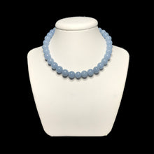 Load image into Gallery viewer, Pale blue necklace on a white stand
