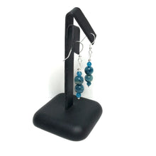 Load image into Gallery viewer, Blue gemstone drop earrings on a black stand
