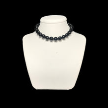 Load image into Gallery viewer, Black crystal necklace on a white stand
