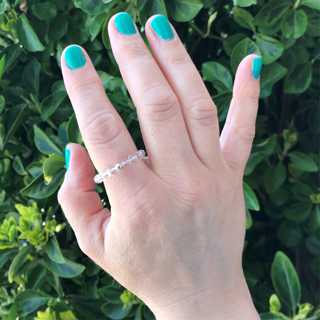Hand wearing a clear quartz ring