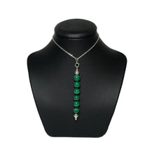 Load image into Gallery viewer, Green crystal bead pendant on a black stand
