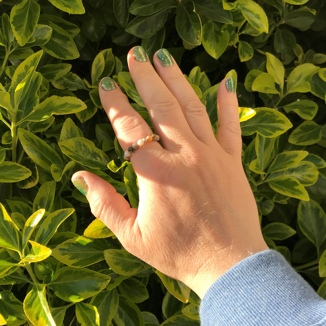 Hand wearing an ocean jasper stretch ring