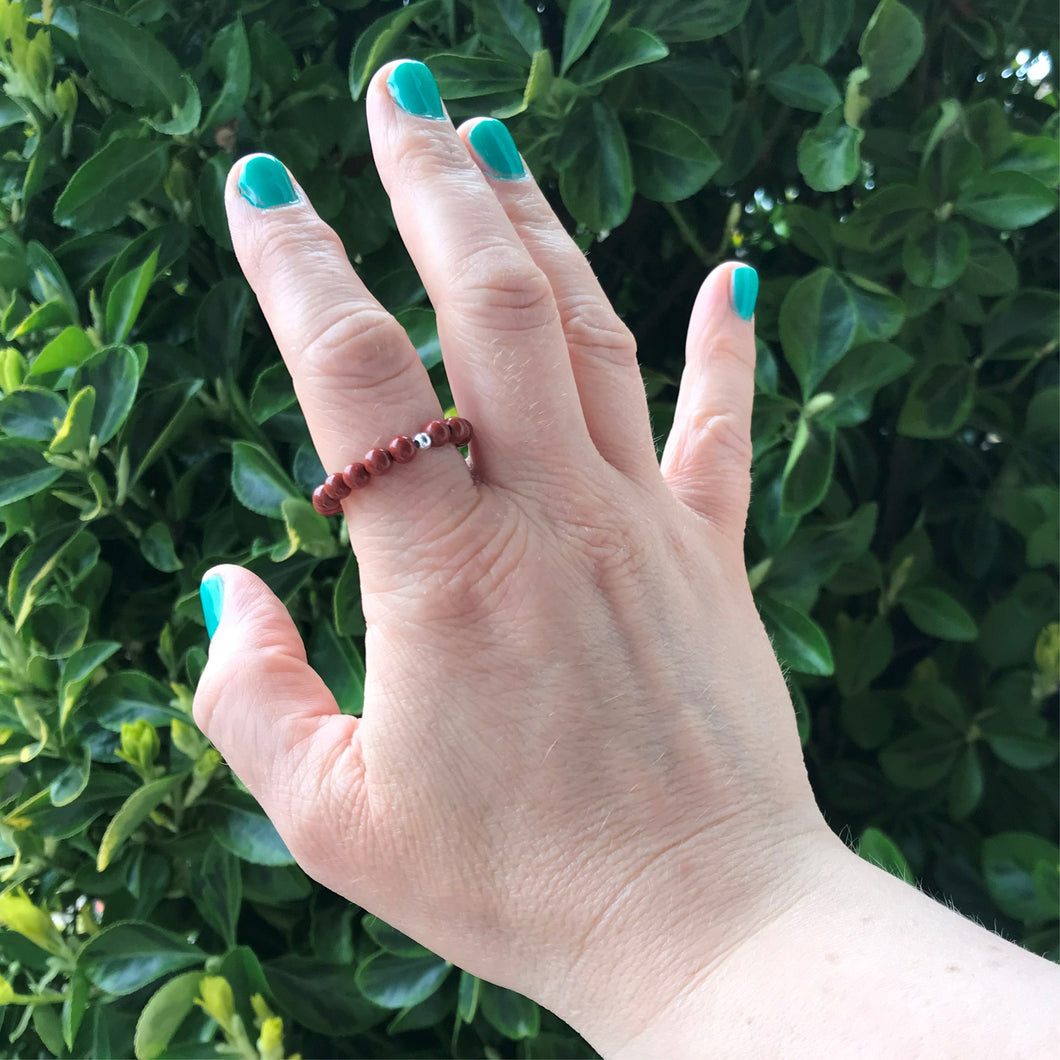 Hand wearing red jasper ring