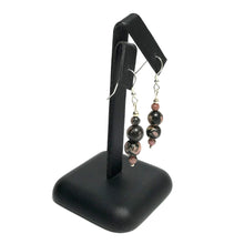 Load image into Gallery viewer, Rhodonite earrings on a stand
