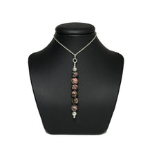 Load image into Gallery viewer, Rhodonite pendant on a stand
