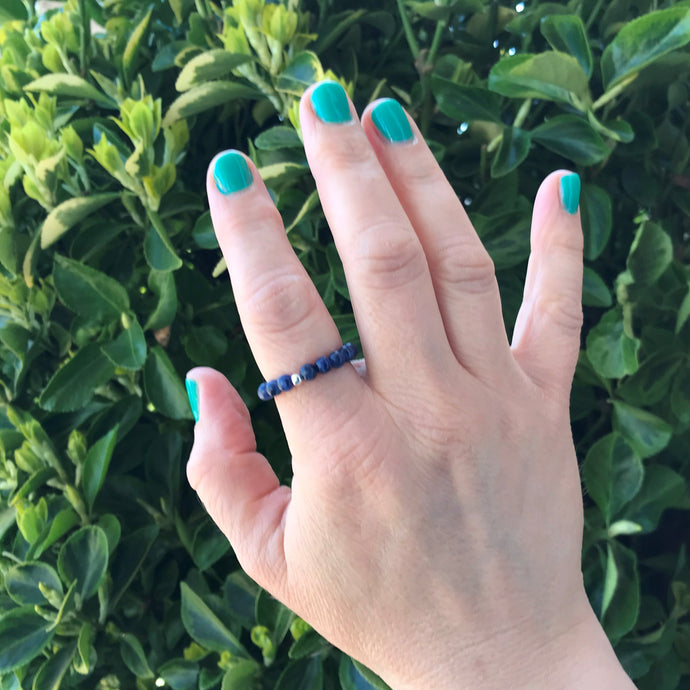 Hand wearing a sodalite beaded stretch ring