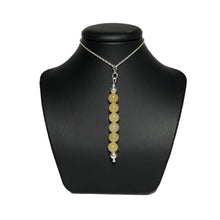 Load image into Gallery viewer, Yellow gemstone pendant necklace on a black stand
