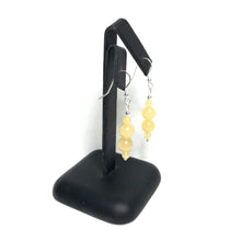 Load image into Gallery viewer, Yellow gemstone drop earrings on a stand
