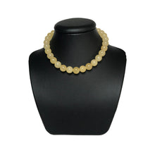 Load image into Gallery viewer, Yellow gemstone necklace on a black stand
