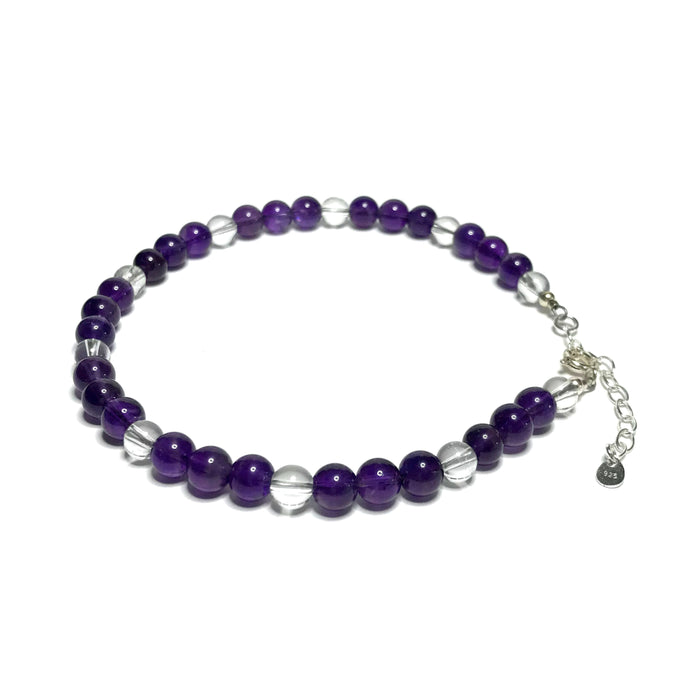 A amethyst and clear quartz beaded anklet with  a sterling silver extender chain.