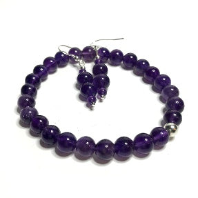 An amethyst stretch bracelet with a pair of matching beaded drop earrings.