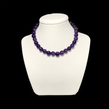 Load image into Gallery viewer, A beaded amethyst handmade necklace on a white stand.
