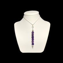 Load image into Gallery viewer, Amethyst pendant on a white stand.
