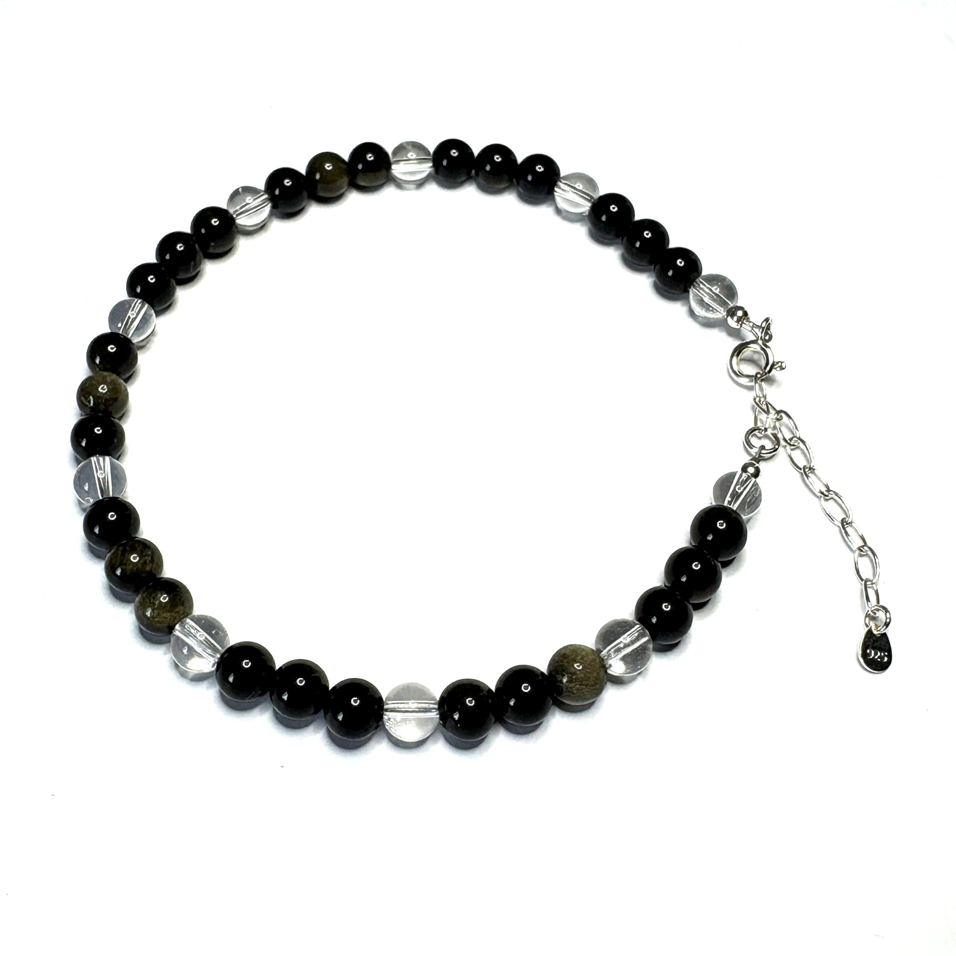 Beaded bracelet with black, silver, and clear beads on a white background