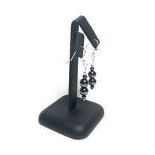 Load image into Gallery viewer, Hematite drop earrings on stand
