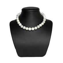 Load image into Gallery viewer, Howlite beaded necklace on stand
