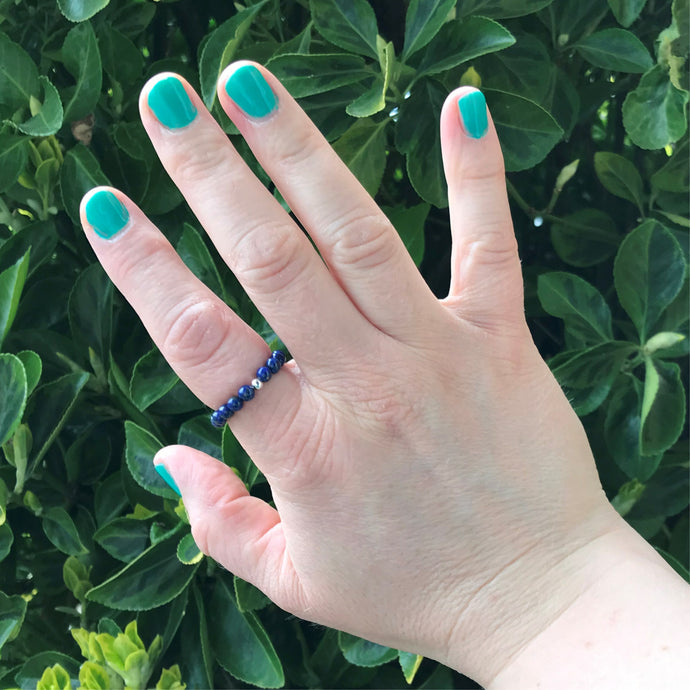 Hand wearing a lapis lazuli crystal ring