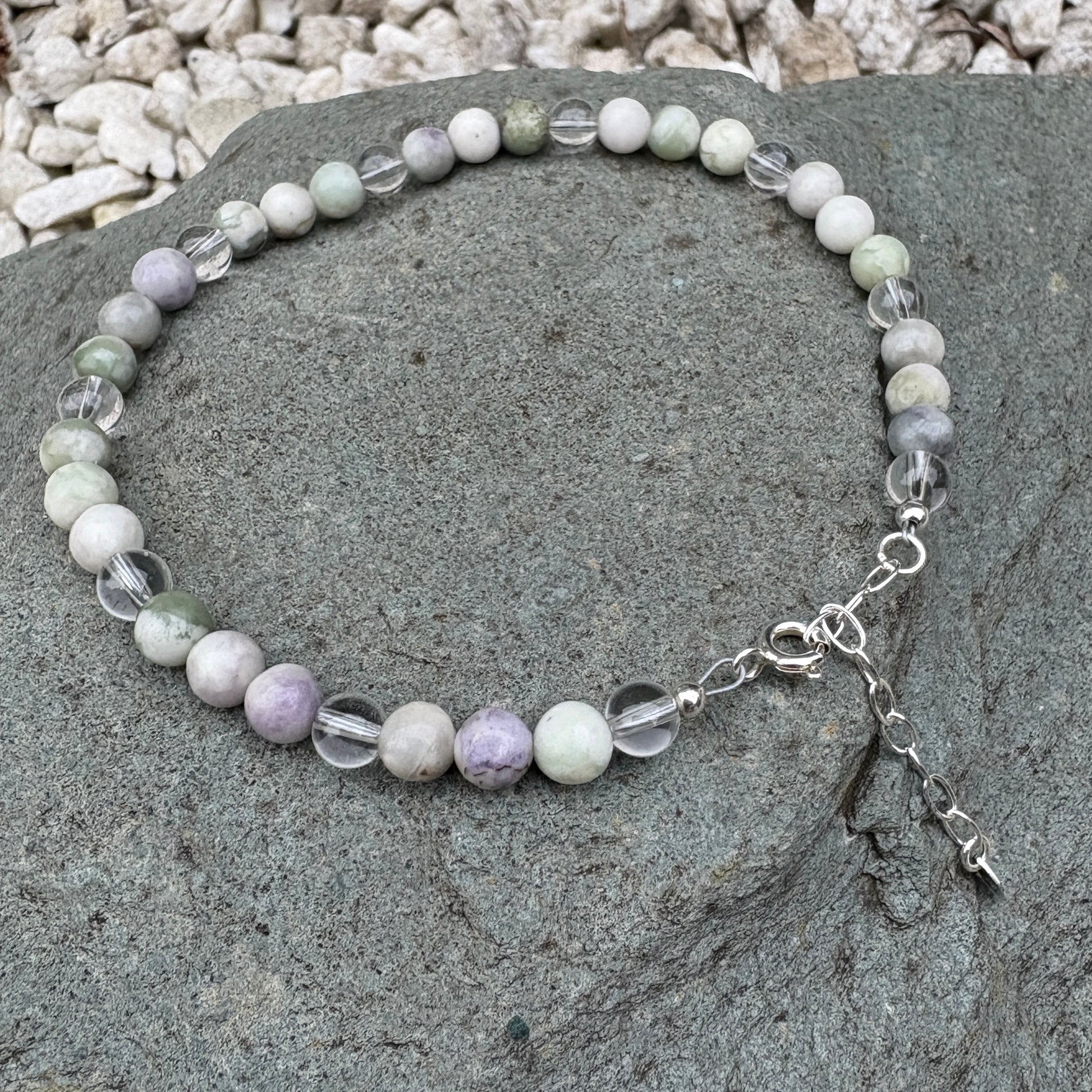 Peace Jade anklet on a stone surface