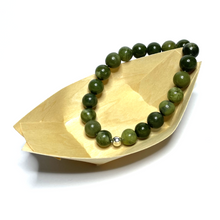 Load image into Gallery viewer, Handmade 10mm nephrite jade bracelet in a wooden basket
