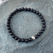 Load image into Gallery viewer, Handmade 6mm matte onyx bracelet on a piece of slate outside
