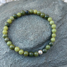 Load image into Gallery viewer, Handmade 6mm nephrite jade bracelet on a piece of slate outside
